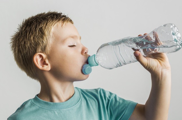cute kid drinking water from plastic bottle 23 2148300975